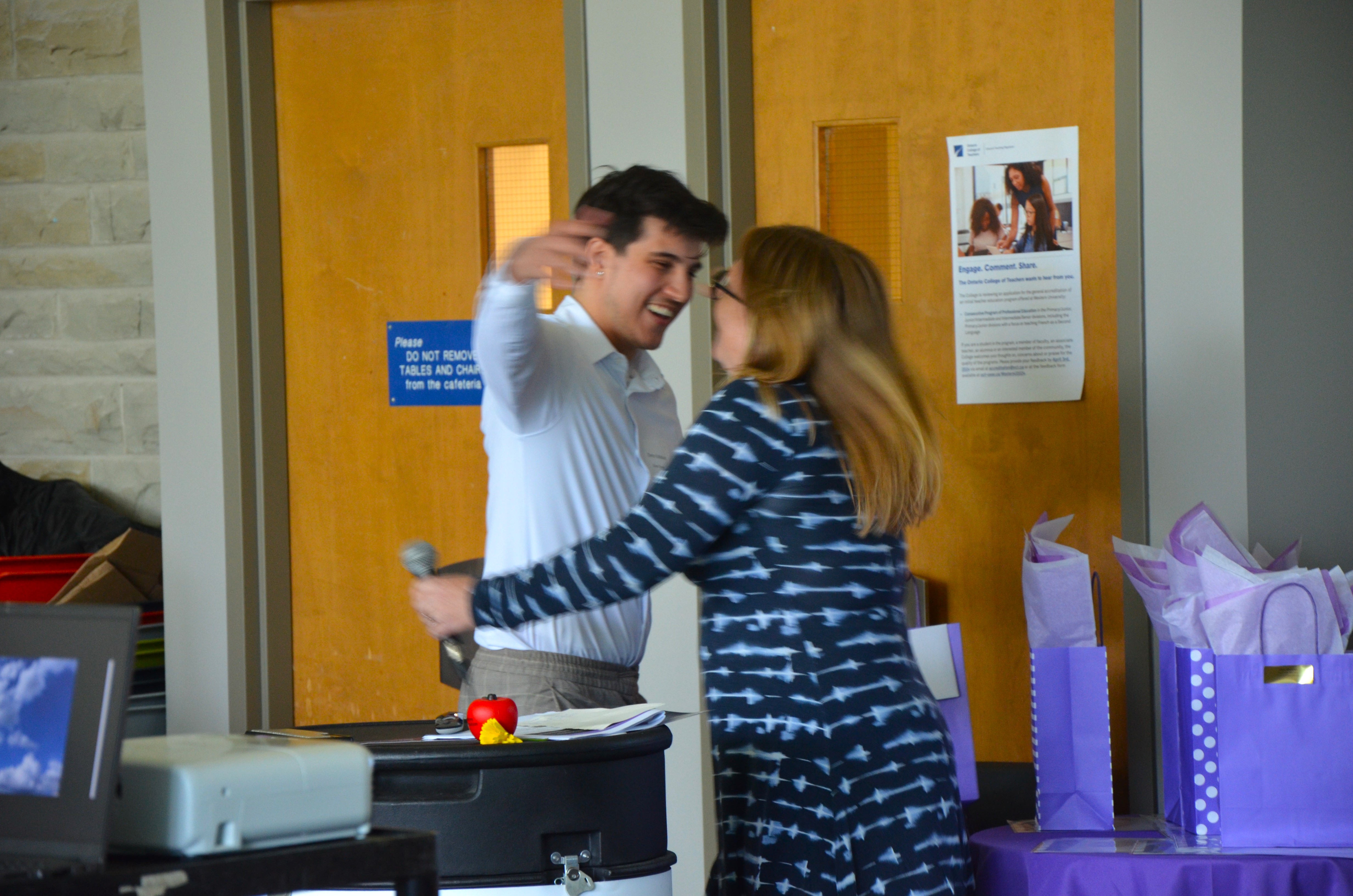 Demo Kaltabanis goes in for a hug with Teacher Education Manager Clare Tattersall after delivering an emotional address.