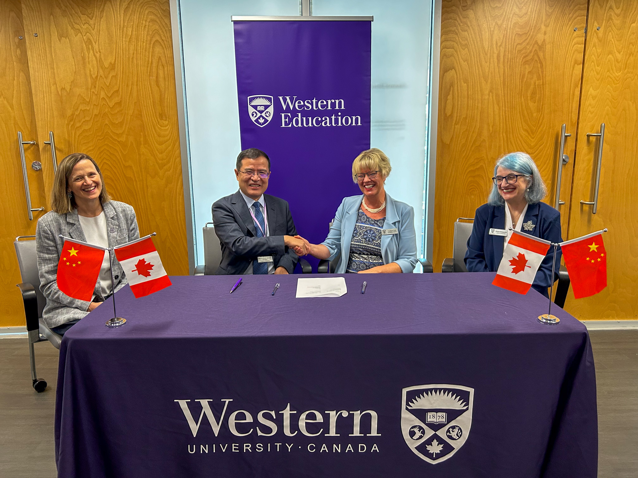 Florentine Strzelczyk, Western’s provost & vice-president (academic) shakes hands with Zhongying Shi, Dean and Professor of the School of Education, Tsinghua University accompanied by Donna Kotsopoulos, dean of Education and Penny Pexman, Western’s vice-president (research)